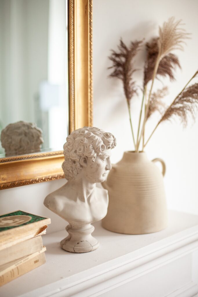 Mantle accessorized with personal, antique items. 