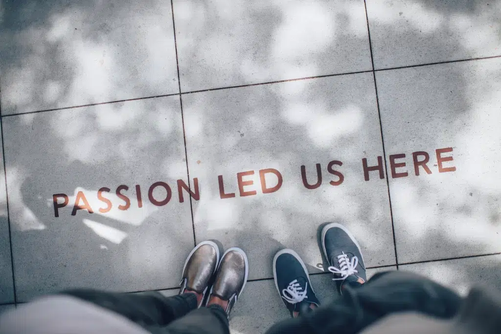 A sidewalk with "passion led us here" written on it. 